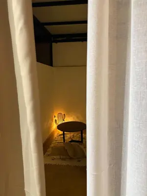 a table in a room with a light behind a curtain at Cosy Loft with Sauna - City Center Casablanca in Casablanca
