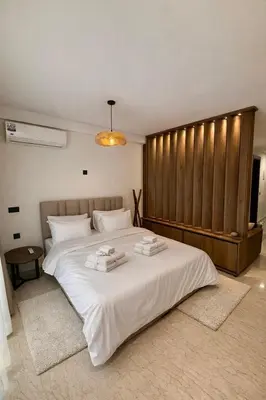 a bedroom with a large bed with two towels on it at Cosy Loft with Sauna - City Center Casablanca in Casablanca