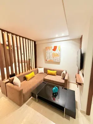 a living room with a couch and a coffee table at Cosy Loft with Sauna - City Center Casablanca in Casablanca