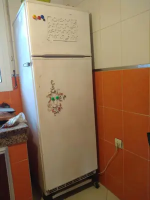 a white refrigerator in a kitchen with magnets on it at dar lhajja in Temara