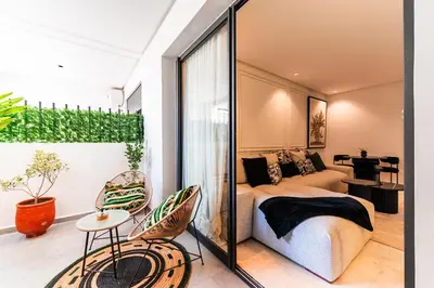 a living room with a couch and a table at Studio moderne & cosy - CFC - Maarif in Casablanca