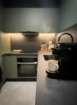 a kitchen with a cup of coffee on a counter at Studio moderne & cosy - CFC - Maarif in Casablanca