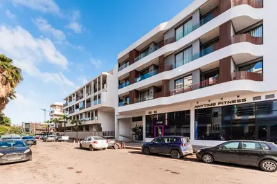 a building with cars parked in front of it at Studio moderne & cosy - CFC - Maarif in Casablanca