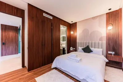 a bedroom with a large white bed and wooden walls at Studio moderne & cosy - CFC - Maarif in Casablanca