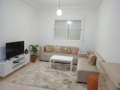 a living room with a couch and a tv at Ouma in Casablanca
