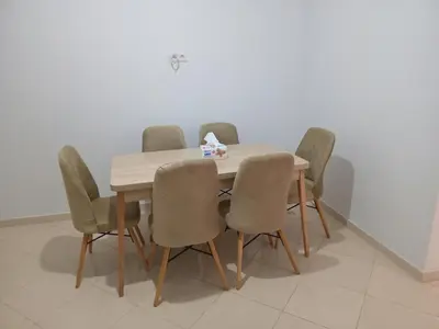 a dining room table with six chairs around it at Ouma in Casablanca