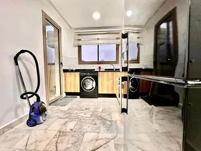 a laundry room with a washer and dryer in it at Elegant apartment in Nouaceur, Close to Airport in Nouaseur