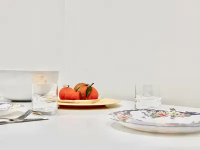 a table with a plate and a glass of water and apples at Elegant apartment in Nouaceur, Close to Airport in Nouaseur