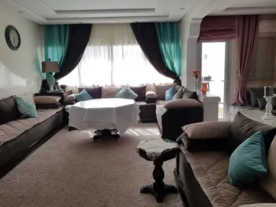 a living room with a couch and a table at Sea view Apart Rabat in Rabat
