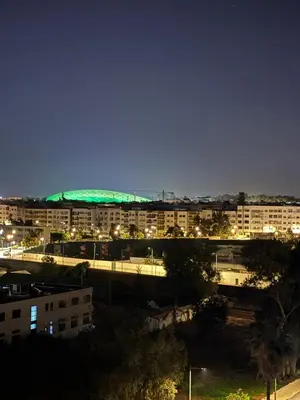 a view of a city at night with buildings at Appartement cosy 2 chambres à Agdal, à 5 min de la Gare in Rabat