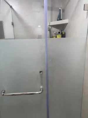 a white refrigerator in a room with a pole at Appt Mansbay beach in Mansouria