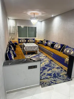 a living room with a couch and a table at Appartement central à Témara, trés proche de Rabat Av Tarik Ibn Zaid in Temara