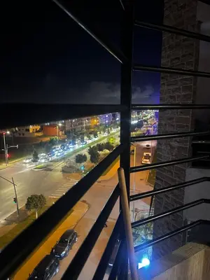 a view of a city street at night from a balcony at Appartement central à Témara, trés proche de Rabat Av Tarik Ibn Zaid in Temara