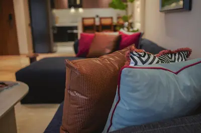 a couch with pillows on it in a living room at Marhaba Experience Appartement Luxe Belvedere in Casablanca
