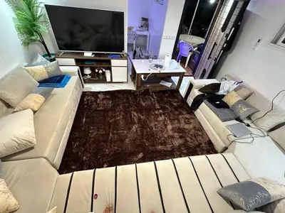 a living room with a couch and a tv at Appartement meublée à RABAT for CAN 2025 in Temara