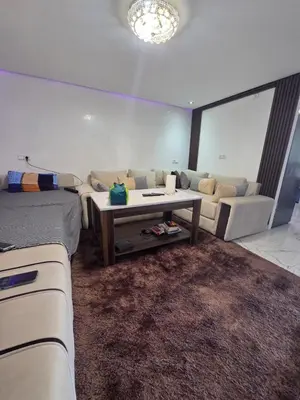 a living room with a couch and a table at Appartement meublée à RABAT for CAN 2025 in Temara