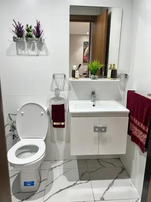 a white bathroom with a toilet and a sink at Studio Glamour centre ville & Casa port in Casablanca