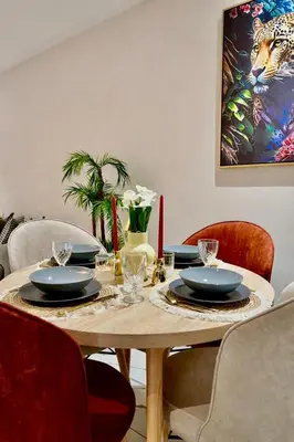 a dining room table with plates and glasses on it at Studio Glamour centre ville & Casa port in Casablanca