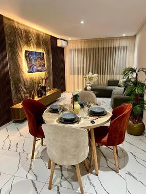 a living room with a table and chairs at Studio Glamour centre ville & Casa port in Casablanca
