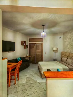 a bedroom with a bed and a couch and a table at Studio Premium à Agdal , Confort et emplacement in Rabat