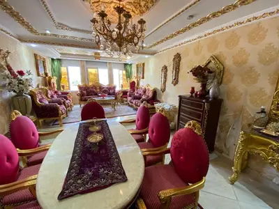 a room with a table and chairs and a chandelier at Appartement prestigieuse en plein cœur de Hay Riad et près du stade Moulay Abdallah in Rabat