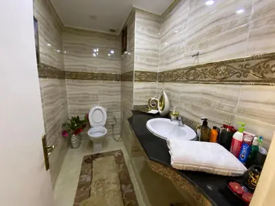 a bathroom with a sink and a toilet at Appartement prestigieuse en plein cœur de Hay Riad et près du stade Moulay Abdallah in Rabat