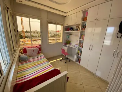 a small bedroom with a bed and a window at Appartement prestigieuse en plein cœur de Hay Riad et près du stade Moulay Abdallah in Rabat