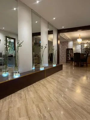a lobby with glass vases with flowers in it at Luxury spacious apartment racine casablanca in Casablanca