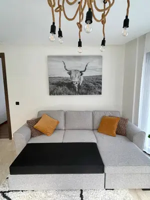a living room with a couch and a picture of a antelope at Spacious Modern Apartment with Large Sunny Terrace in Central Casablanca in Casablanca