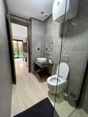 a bathroom with a toilet and a sink at Spacious Modern Apartment with Large Sunny Terrace in Central Casablanca in Casablanca