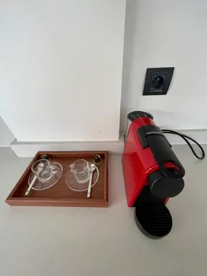 a table with a red sewing machine next to a box at Spacious Modern Apartment with Large Sunny Terrace in Central Casablanca in Casablanca