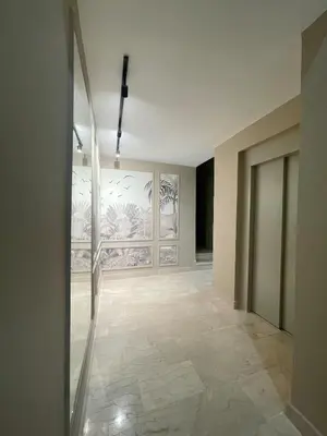 an empty room with a painting on the wall at Spacious Modern Apartment with Large Sunny Terrace in Central Casablanca in Casablanca