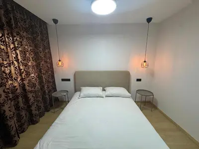 a bedroom with a bed with two pillows on it at Modern Cozy Studio with Open-Plan Kitchen near All Amenities Rabat in Rabat