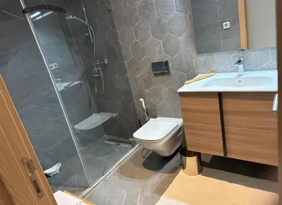 a bathroom with a shower and a toilet and a sink at Carrousel Atlantic View in Rabat