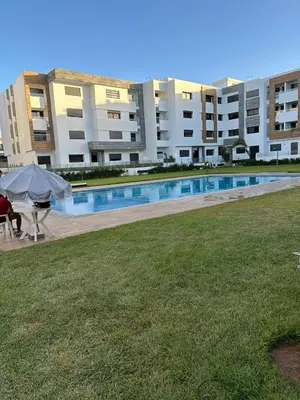 a large apartment building with a large swimming pool at Premium comfort, 150m from Val d'Or beach, 2 swimming pools in Temara