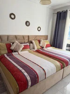 two beds sitting next to each other in a bedroom at Premium comfort, 150m from Val d'Or beach, 2 swimming pools in Temara