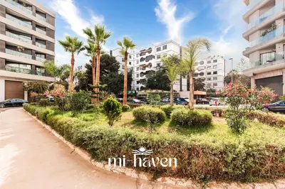 a street in front of a building with palm trees at Sakura - 100 Mbps Wi-Fi - Downtown Casablanca in Casablanca
