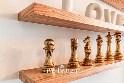 a group of gold chess pieces on a wooden shelf at Sakura - 100 Mbps Wi-Fi - Downtown Casablanca in Casablanca