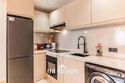 a kitchen with a black refrigerator and a dishwasher at Sakura - 100 Mbps Wi-Fi - Downtown Casablanca in Casablanca