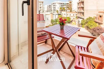 a table on a balcony with a view of a city at Sakura - 100 Mbps Wi-Fi - Downtown Casablanca in Casablanca