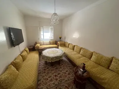 a living room with a couch and a table at Appartement 500 m from Moulay Abdellah Stadium in Temara