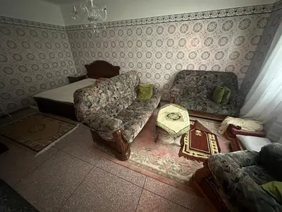 a living room with a couch and a bed at Appartement 500 m from Moulay Abdellah Stadium in Temara