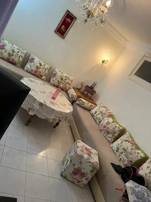 a living room with a couch and a table at Location des appartements souf in Temara