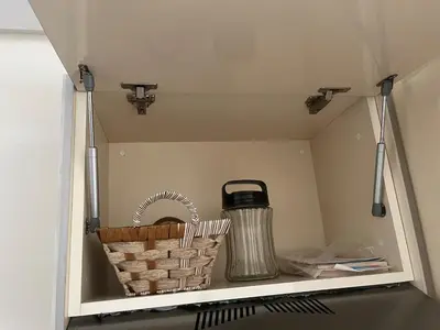 a shelf with two baskets and a thermos in a kitchen at Apartment in a residence with pool in Mohammedia