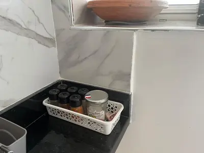 a refrigerator filled with bottles and a bowl on a shelf at Apartment in a residence with pool in Mohammedia