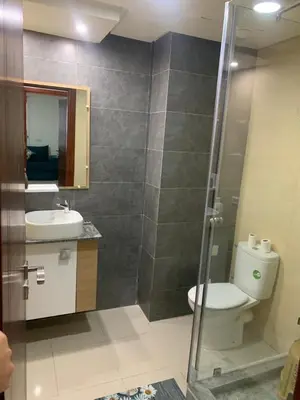 a bathroom with a toilet and a sink and a shower at Apartment in a residence with pool in Mohammedia