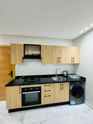 a kitchen with a sink and a stove and cabinets at studio bien aménagé, ambiance chaleureuse 19 in Casablanca