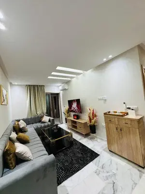 a living room with a couch and a table at studio bien aménagé, ambiance chaleureuse 19 in Casablanca