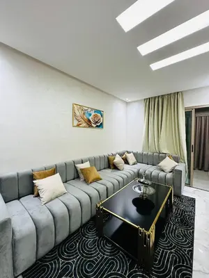 a living room with a couch and a table at studio bien aménagé, ambiance chaleureuse 19 in Casablanca
