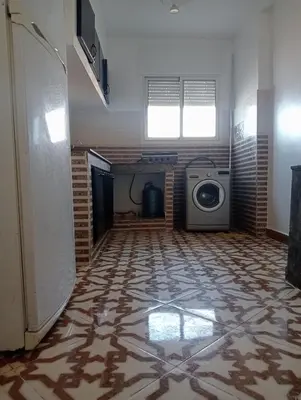 a room with a floor with a washing machine in it at Appartement temara in Temara